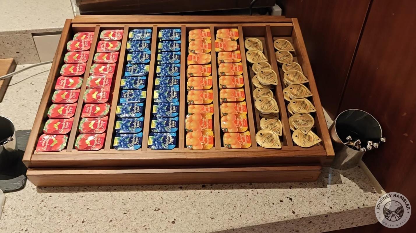 packets of butter, orange marmalade, and strawberry jams