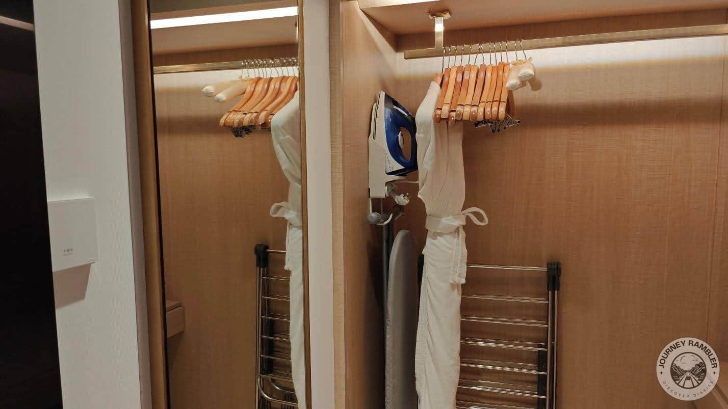 complimentary bathrobe, clothes iron, and ironing horse
