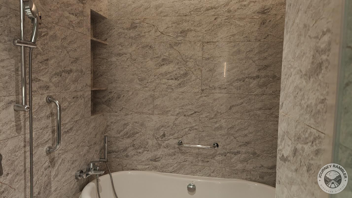 next to the tub is the shower head