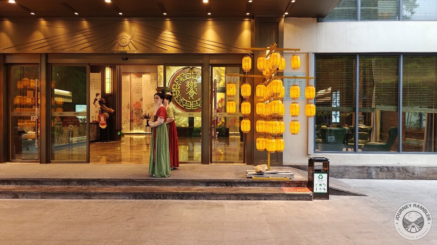 the entrance that featured two people dressed in Hanfu with a lantern rack behind them