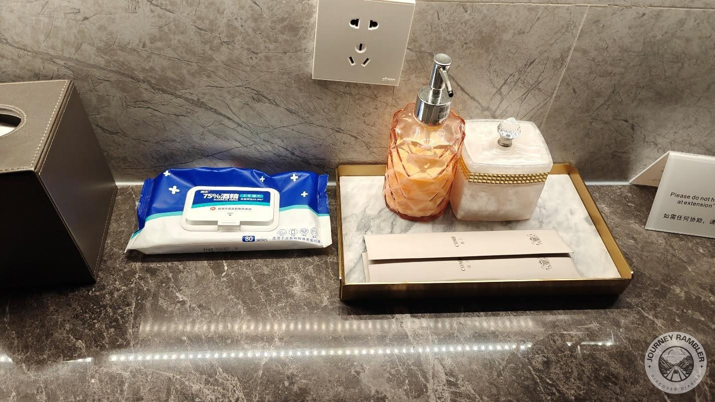 On the countertop are these toiletries that include combs and some lotion