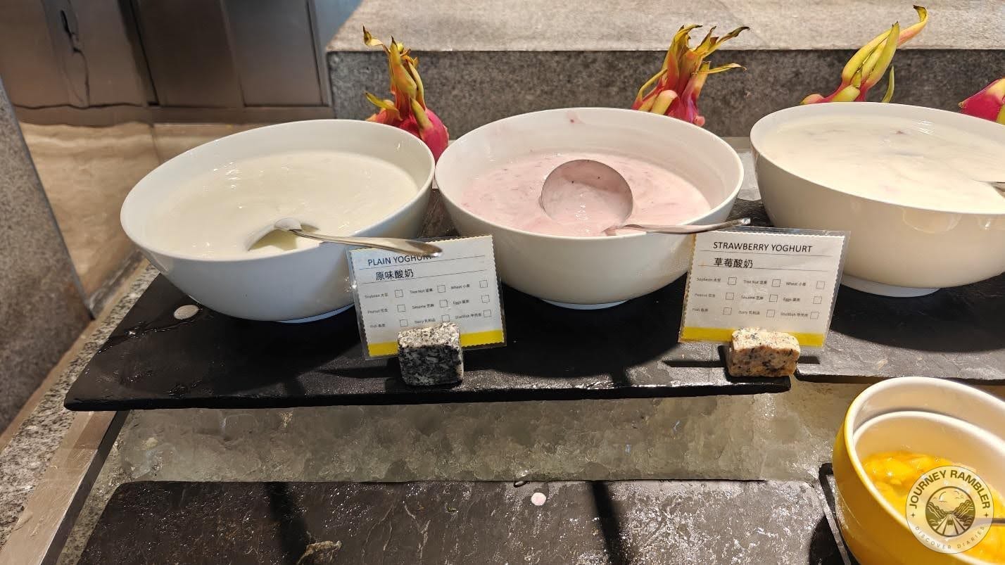 bowl of plain yoghurt right next to the strawberry yoghurt