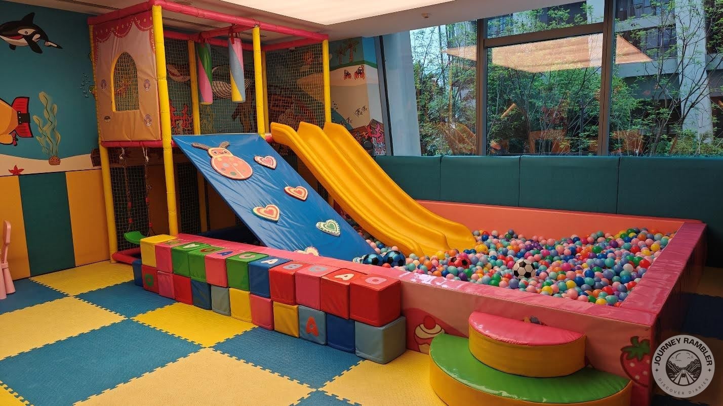 climbing wall and the slide which both connect to a ball pit