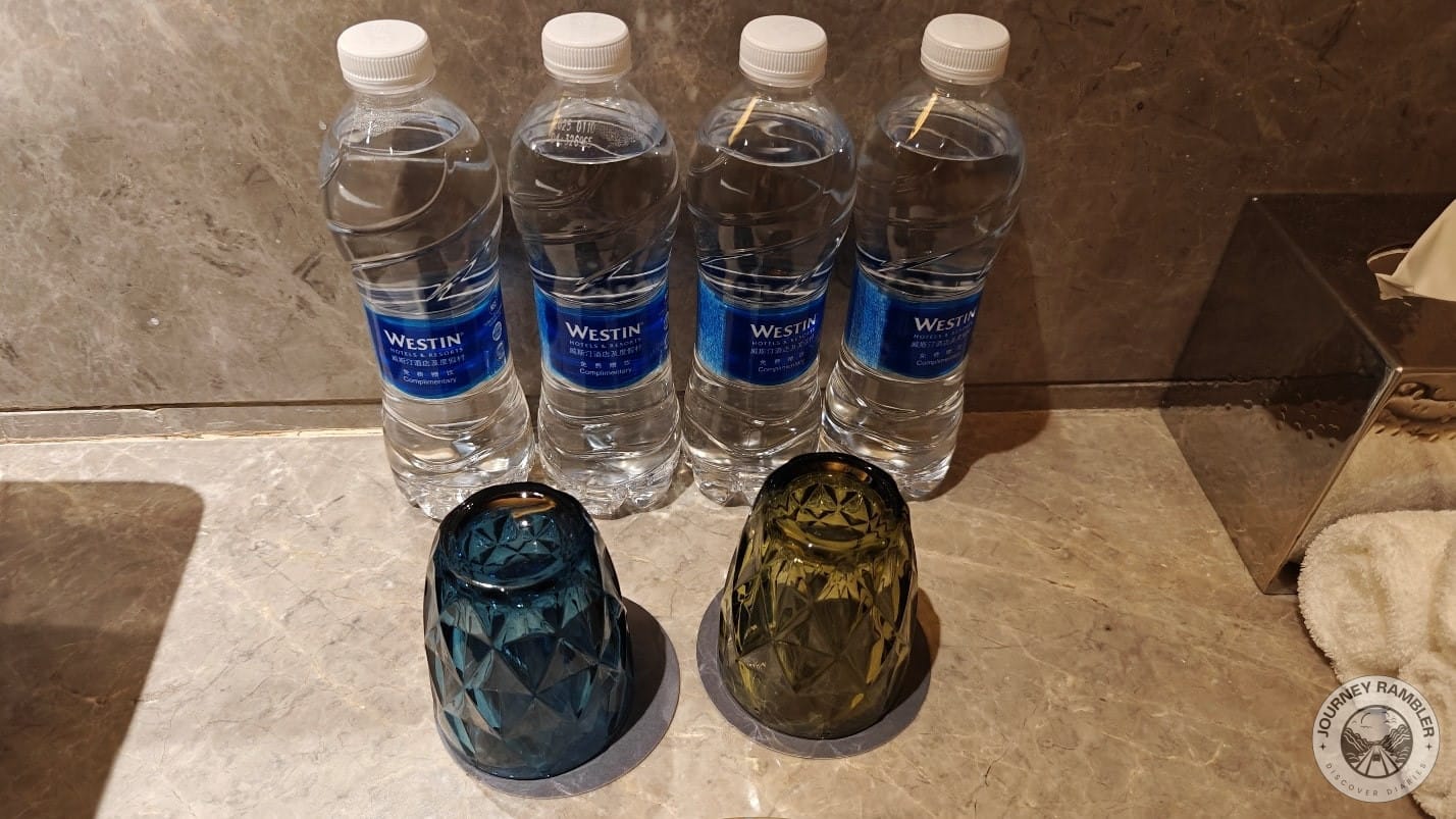 pair of glasses and four bottles of distilled water