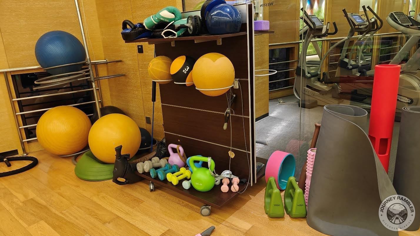 rack with the free weights and other exercise balls