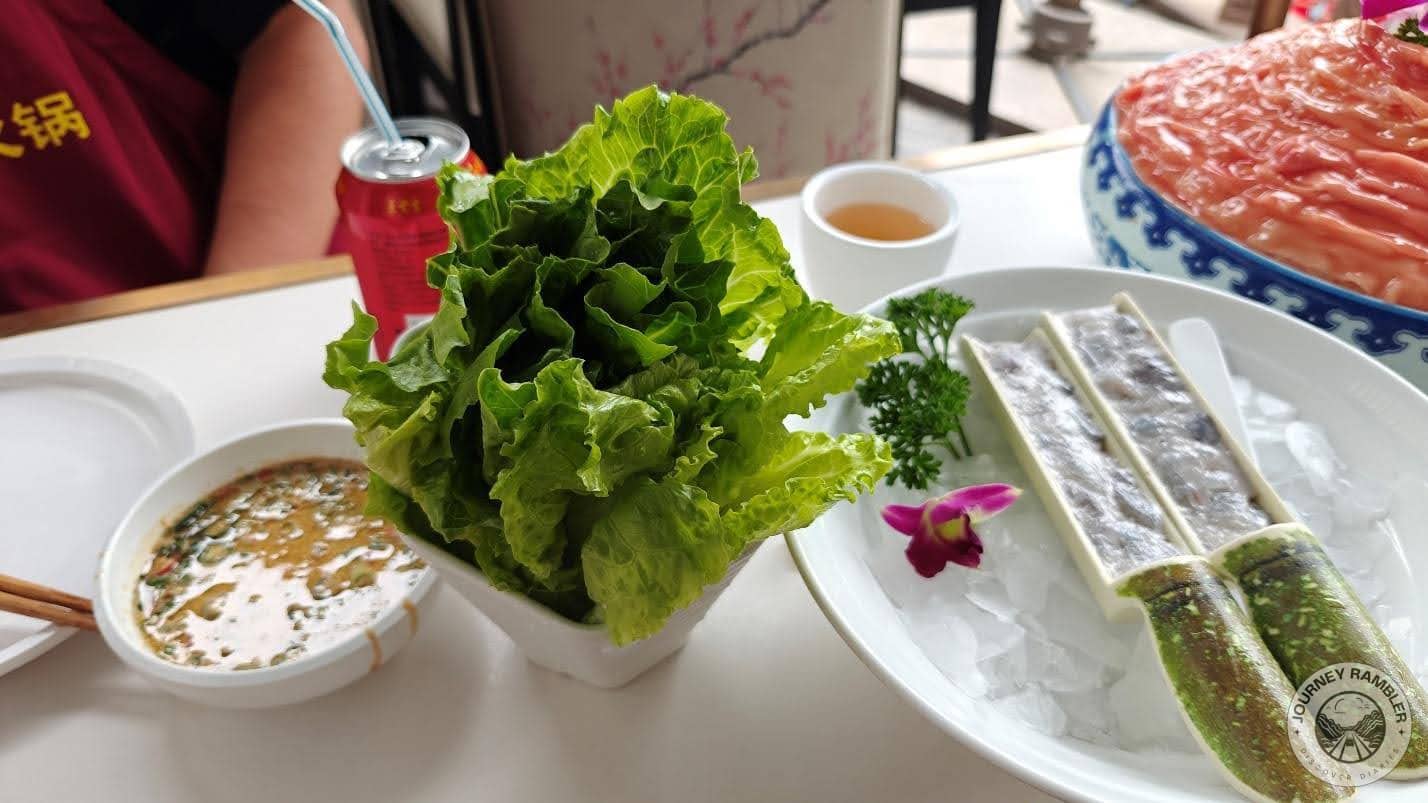 set of greens and a bowl of dipping sauce