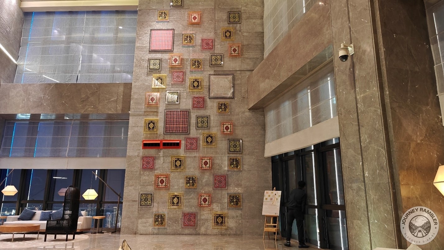 wall that had various kinds of tapestry from top to bottom