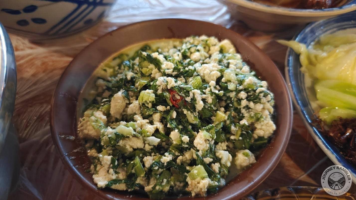 this salad has chrysanthemum and crushed tofu as its main ingredients