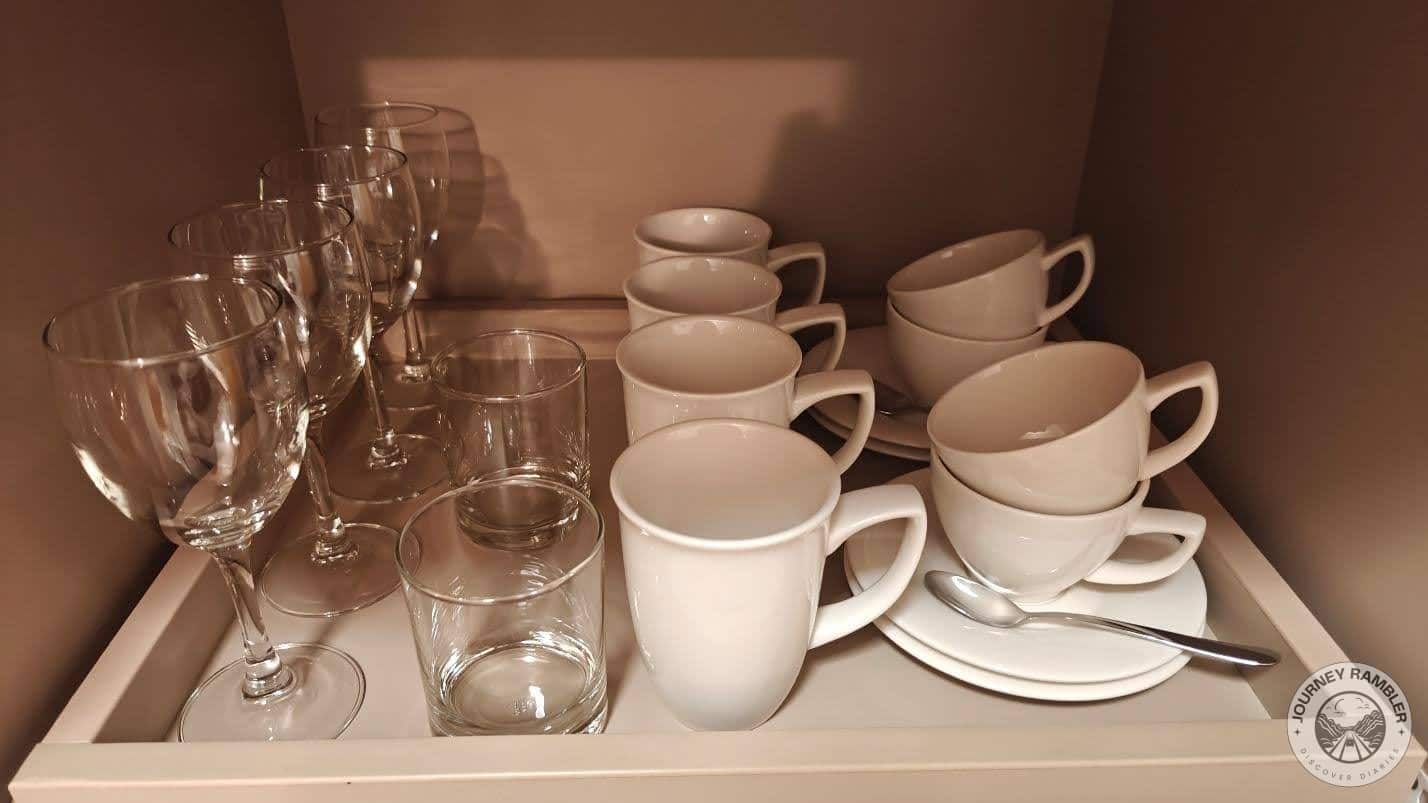 There were enough cups, glasses, mugs and spoons for four people