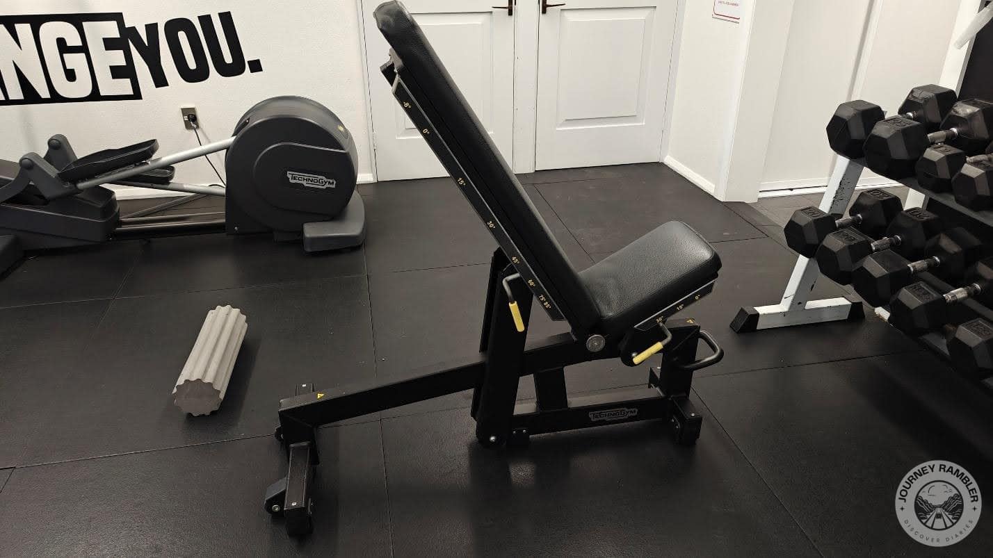 adjustable bench in front of the dumbbells