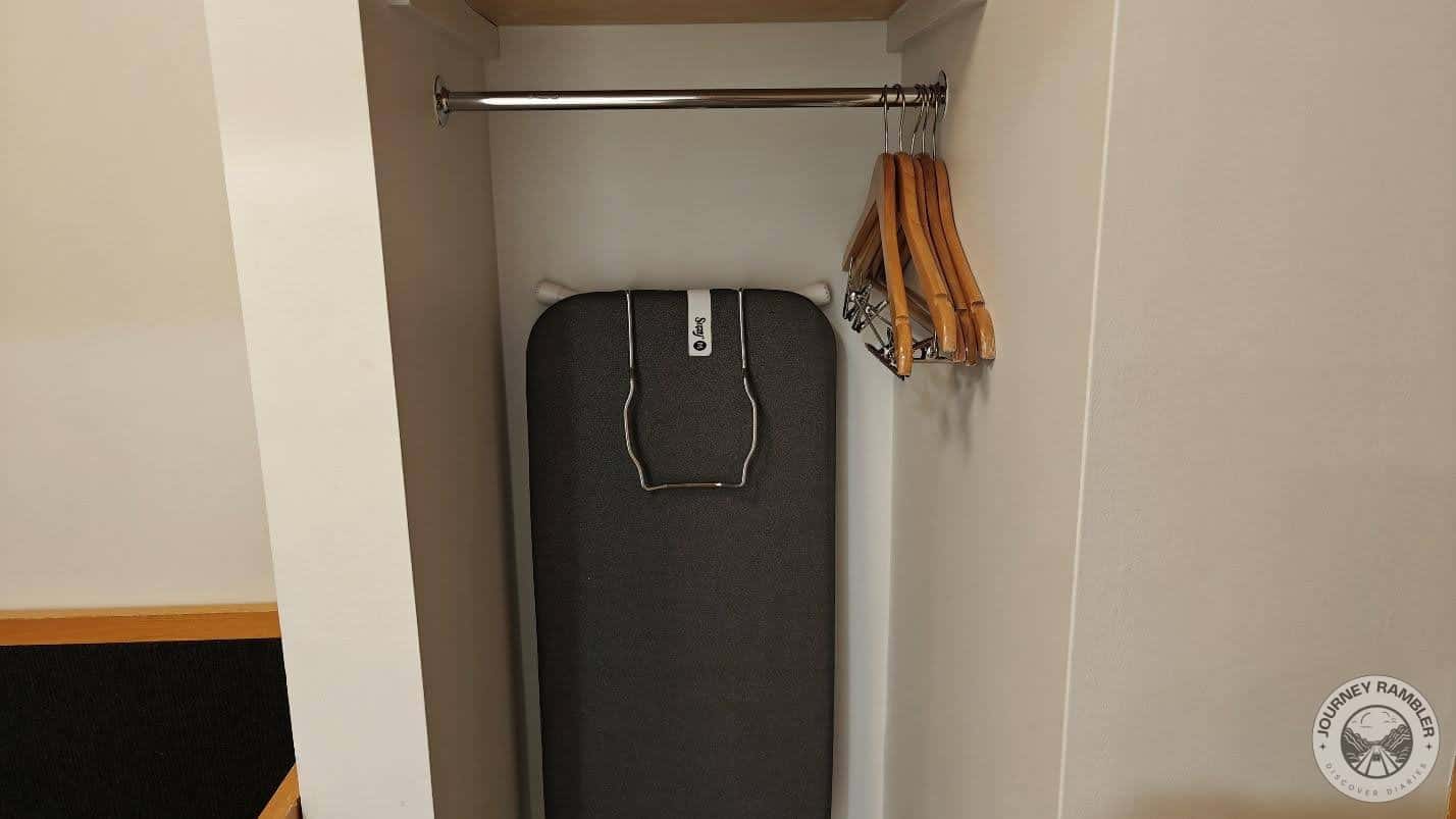 few clothes hangers were hanging on a rod