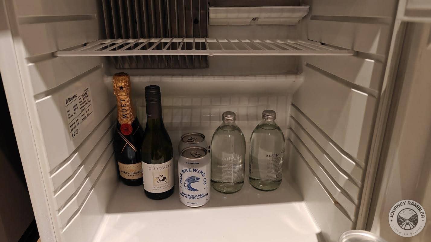 glass bottles of water, cans of beer and bottles of wine