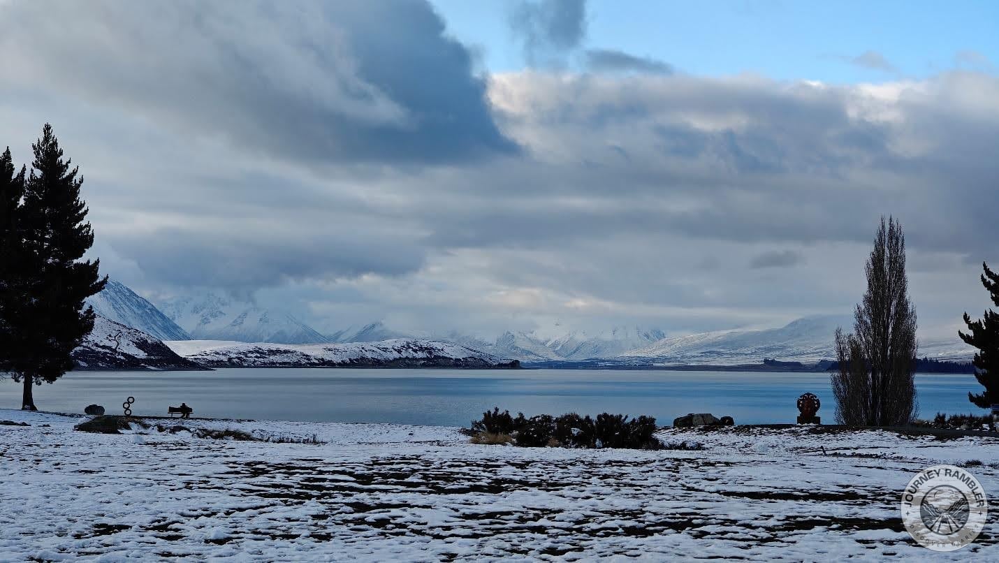 mountains and snow covered hills on all sides of the lake