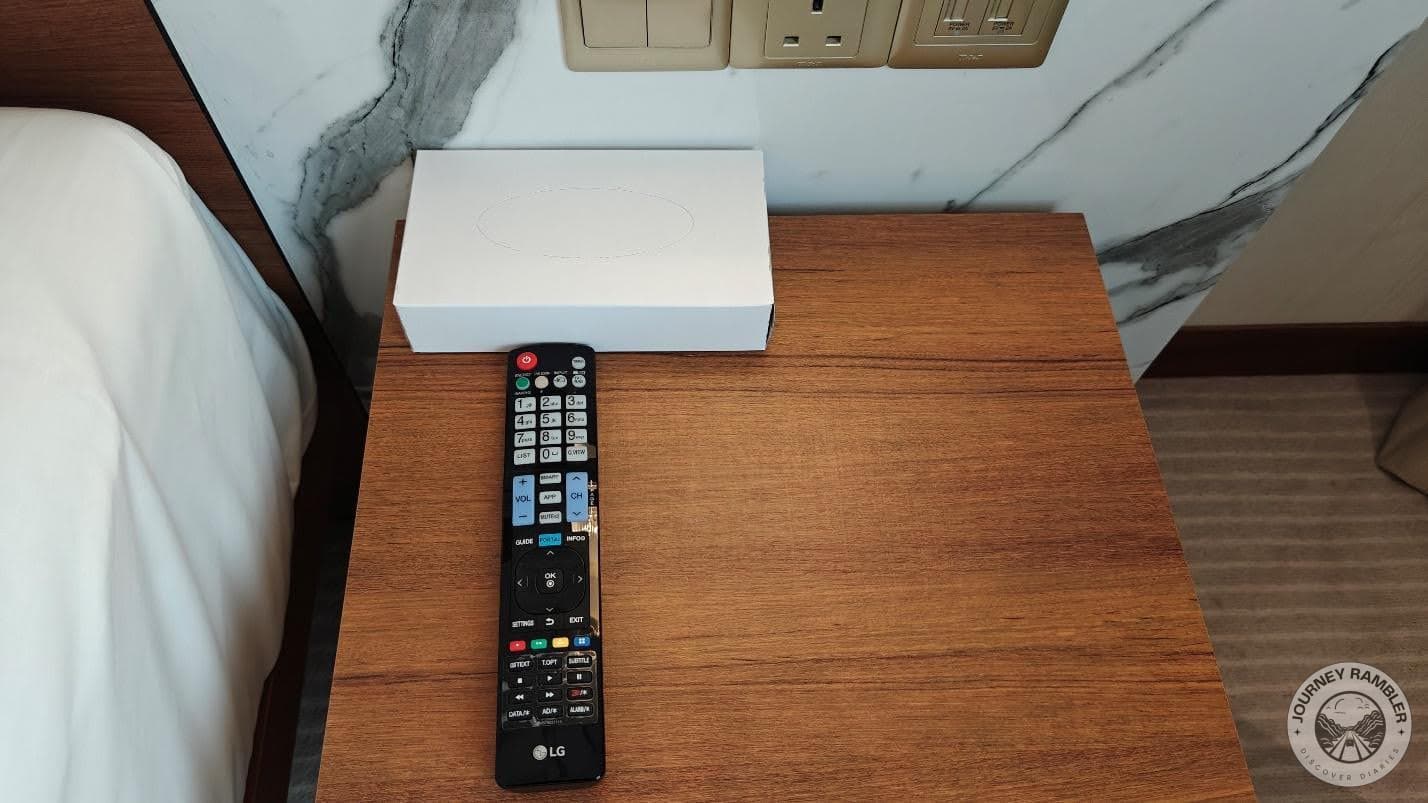 remote control for the TV and a box of wipes