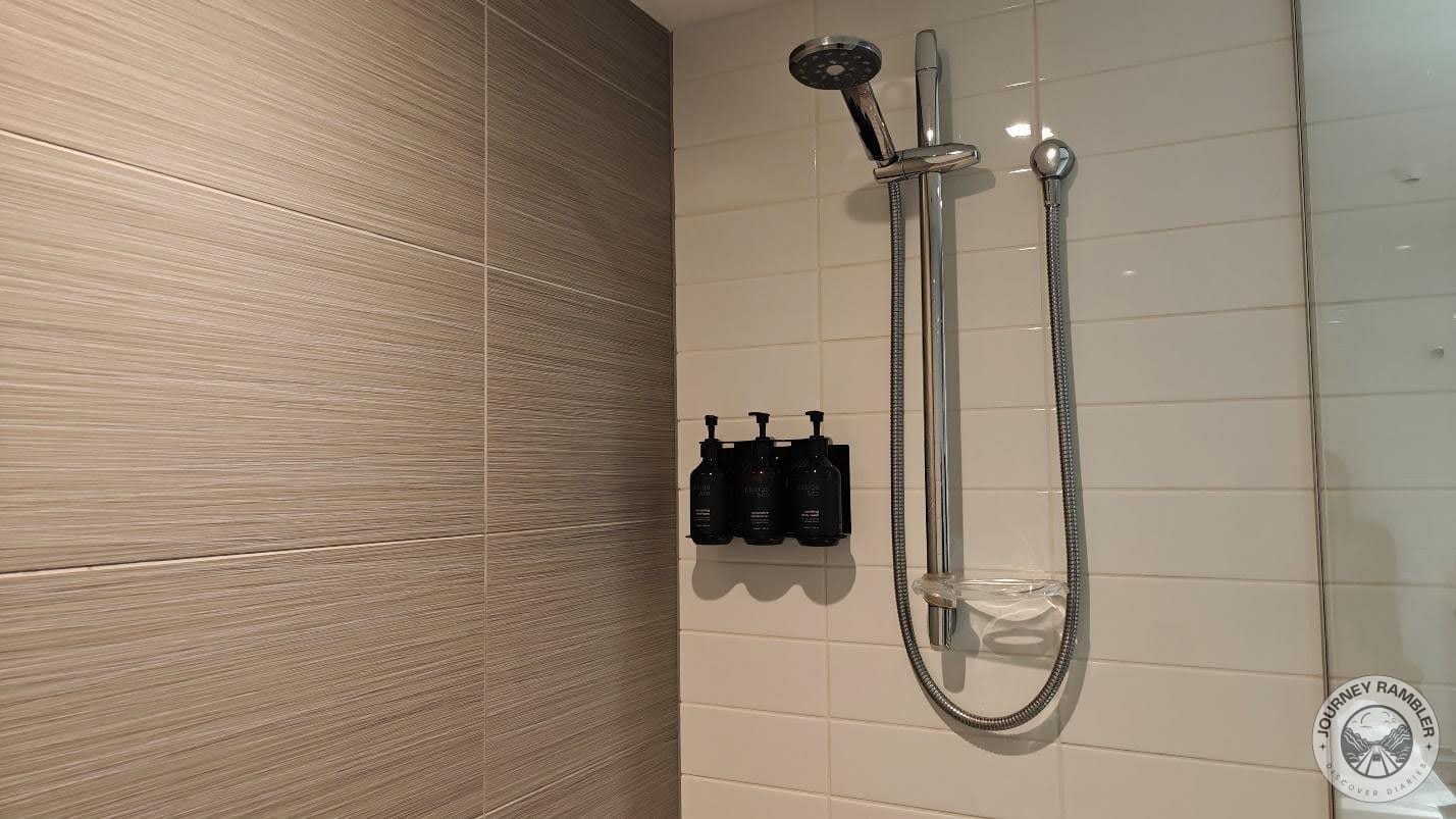 shower was completely enclosed by a glass wall on one side