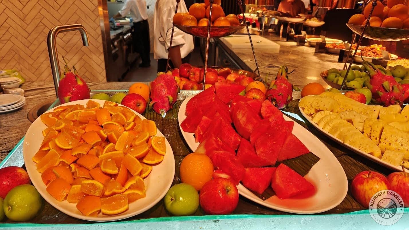 sliced oranges, pineapples, and melons as well as whole apples