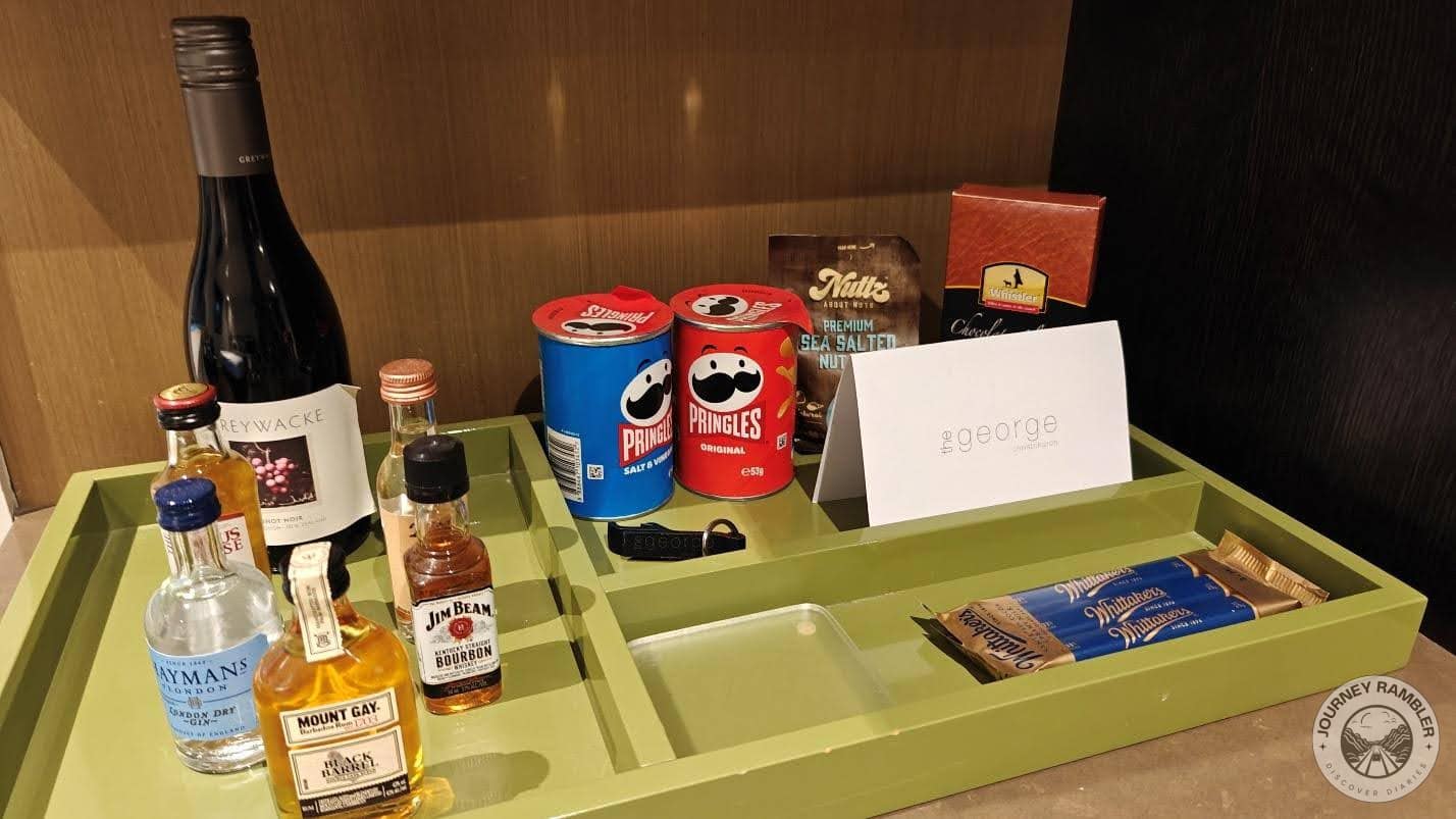 small cartons of Pringles, some chocolates, nuts and some alcoholic beverages