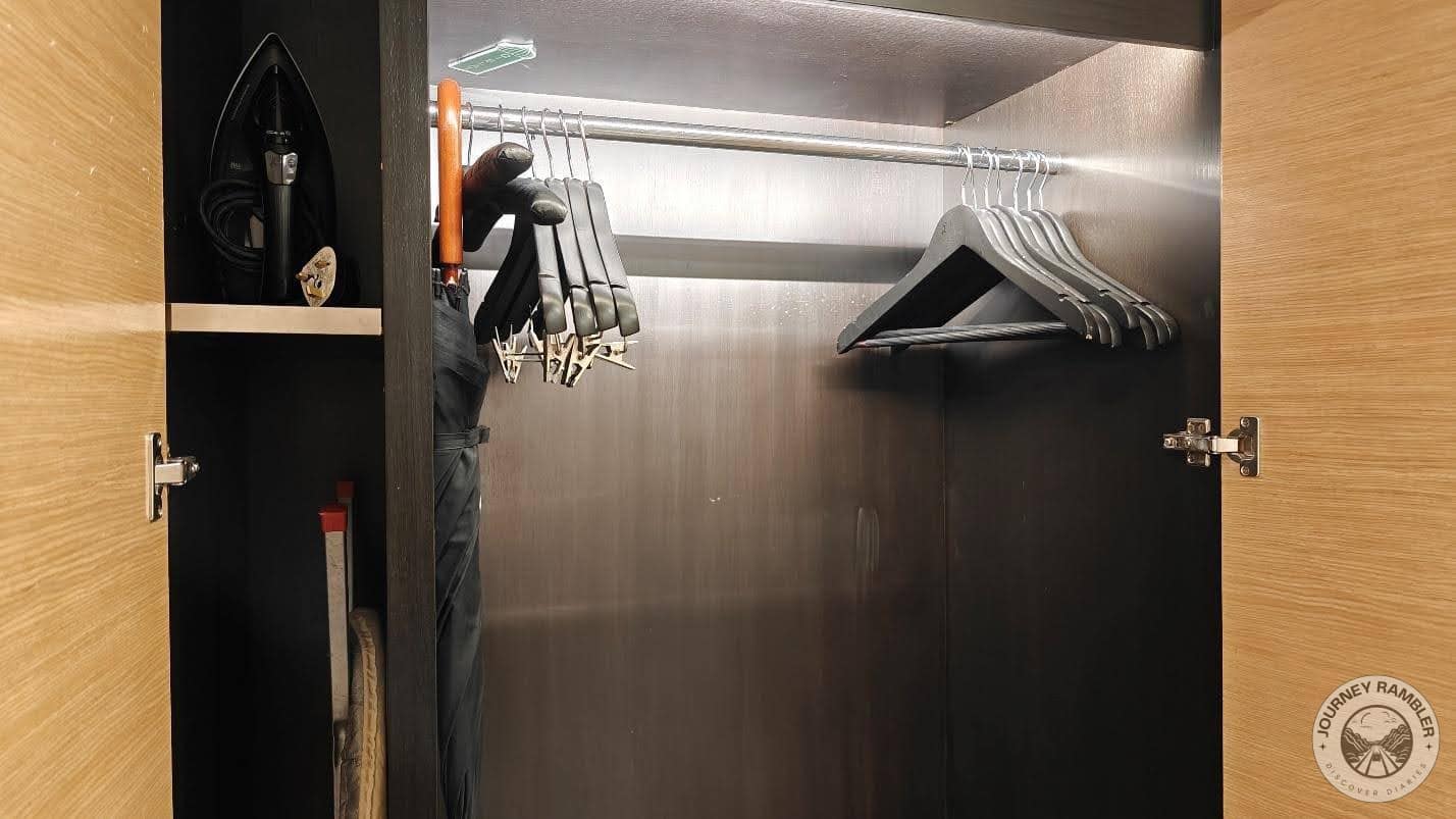some clothes hangers, a clothes iron, and an ironing board