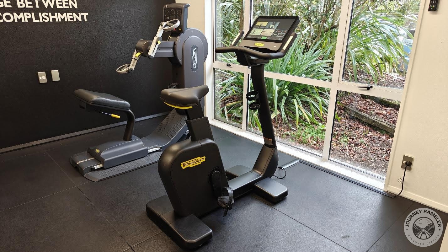upright exercise bike with an upper body ergometer beside it