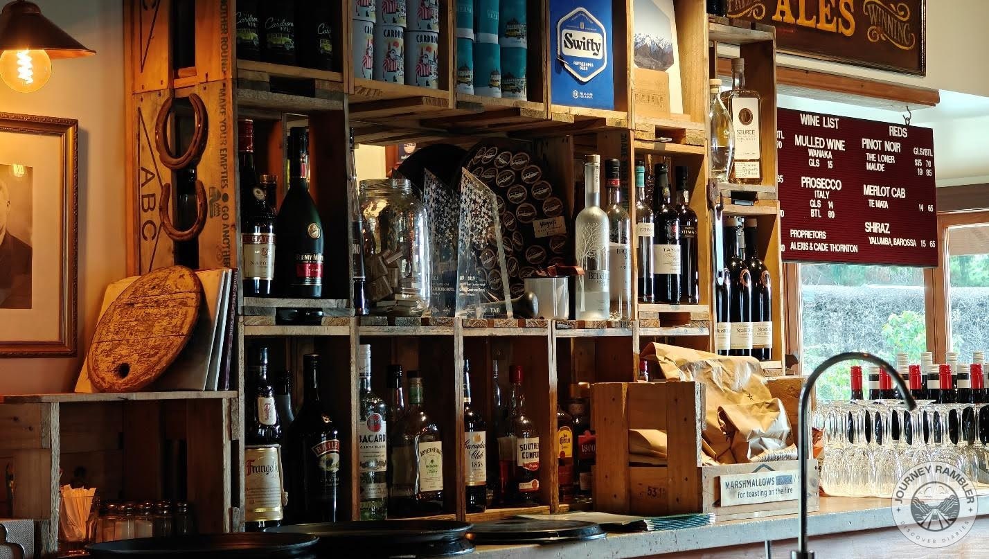 Bottles of alcohol were sitting on shelves behind the bar