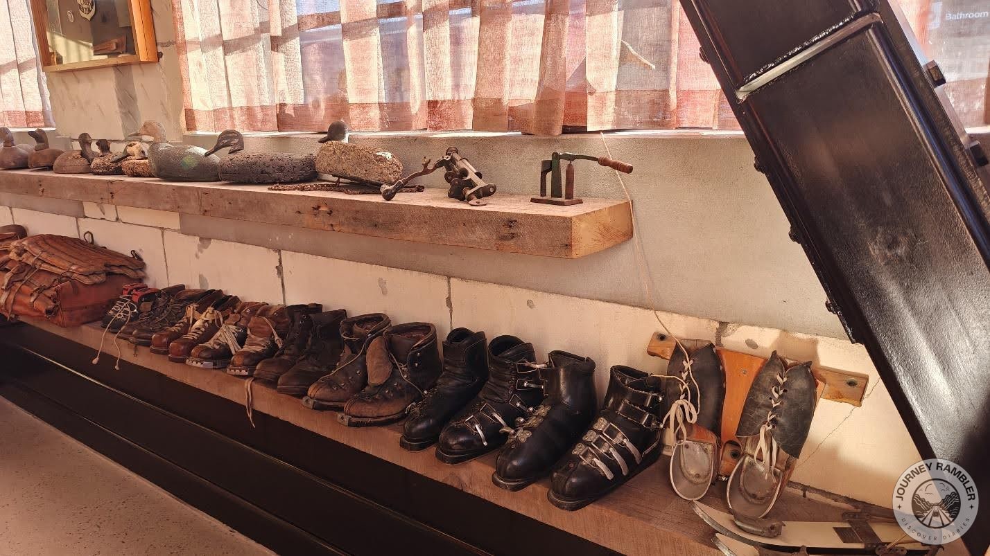 One shelf was filled with old shoes and the shelf above it had sculptures of ducks