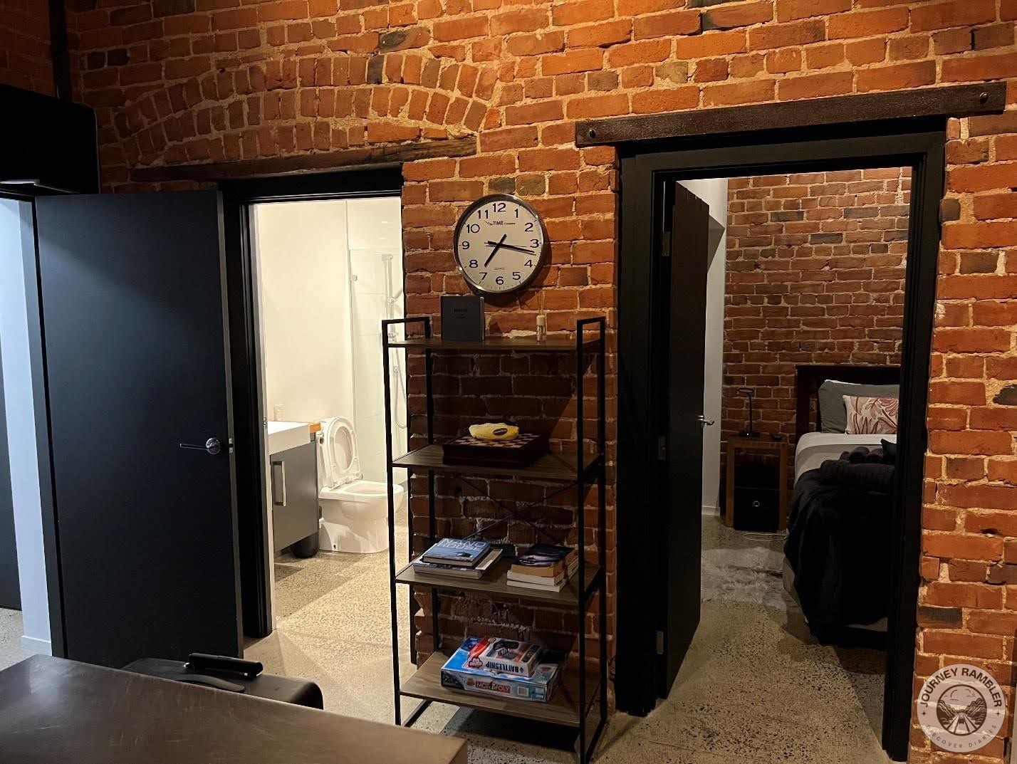 Two doors led to the bedroom and bathroom