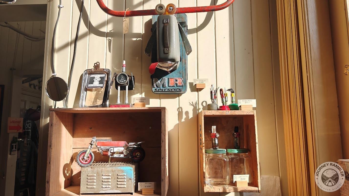 artist had use old pipes and glass jars and door handles to make his sculptures