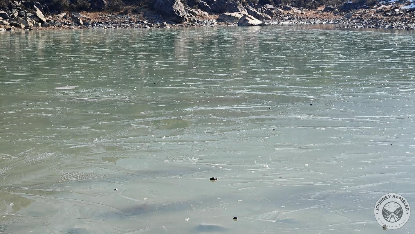 at the opposite end of the lake, you can see what looks to be some ice