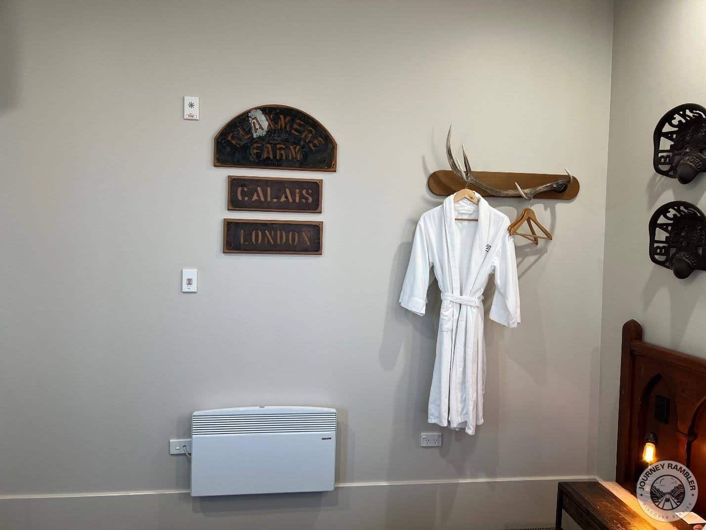 bathrobe and extra clothes hangers hung from another antler shaped hook