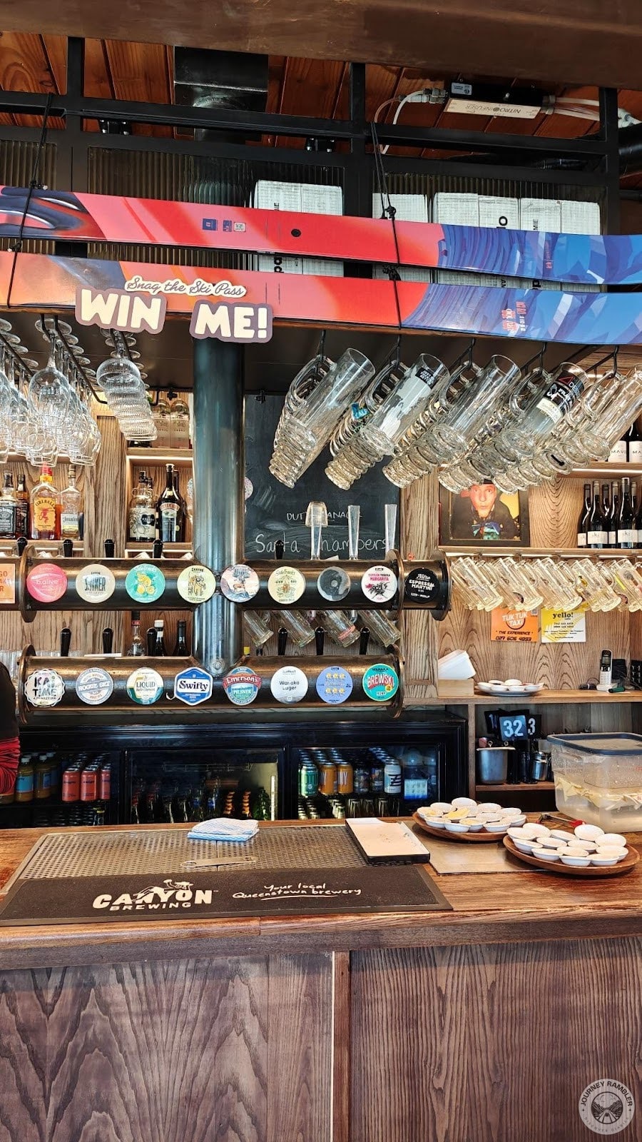 beer and wine glasses hanging above the bar