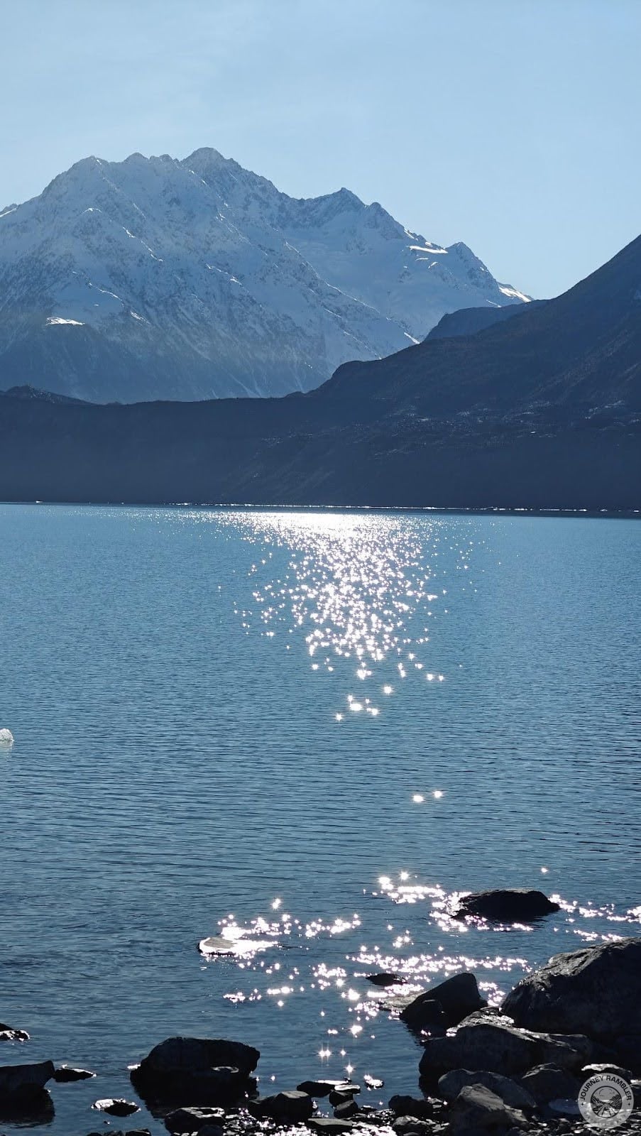 behind the river was a mountain that looked absolutely white with snow