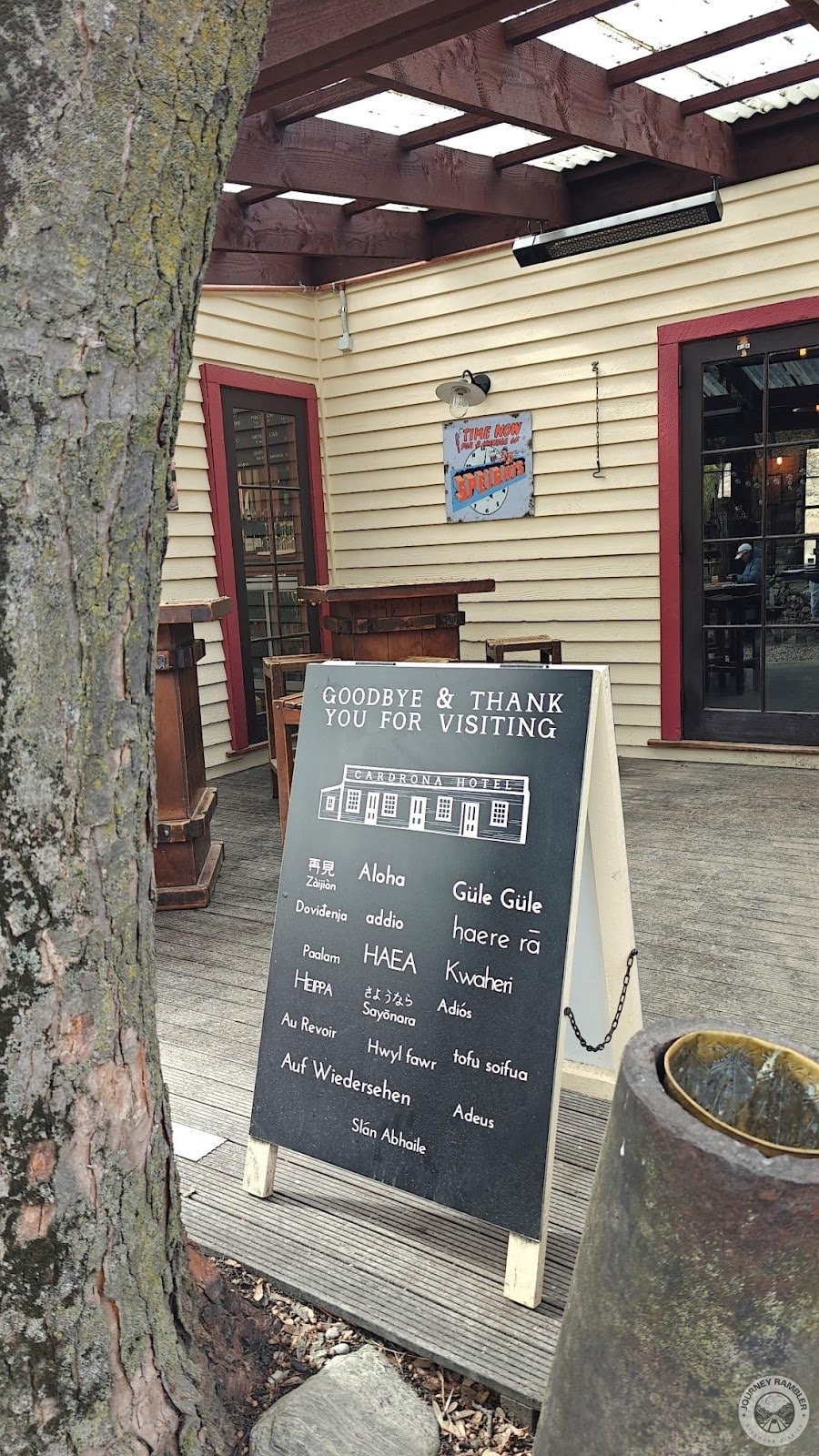 board on the deck of the bar thanking guests for visiting