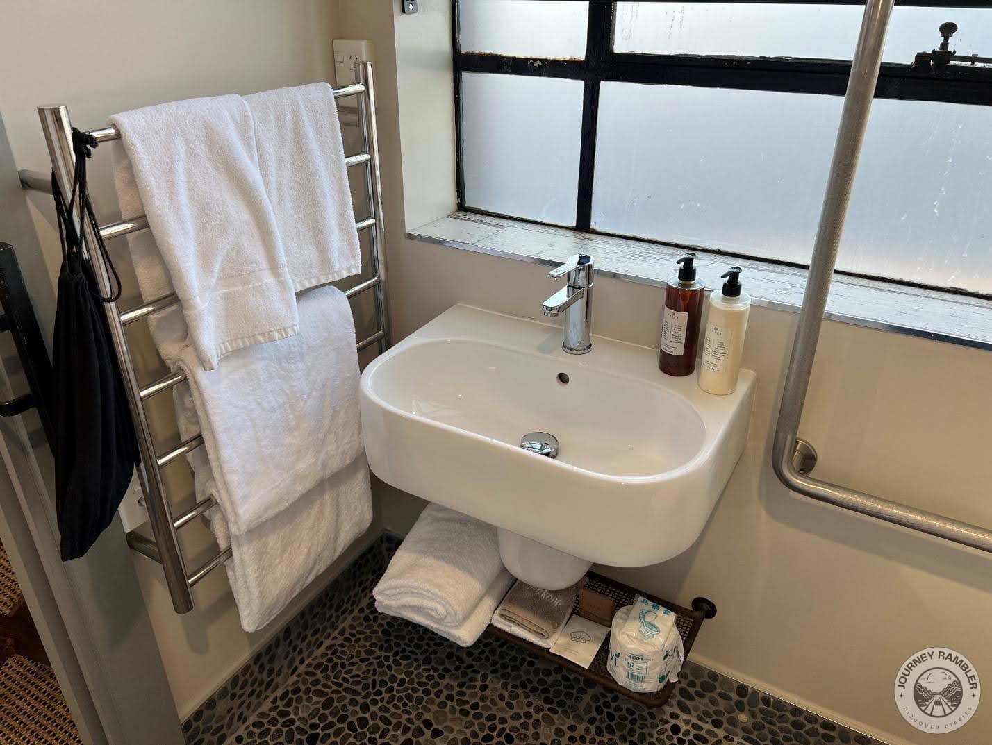 bottles of hand and body wash and lotion on the edge of the washbasin