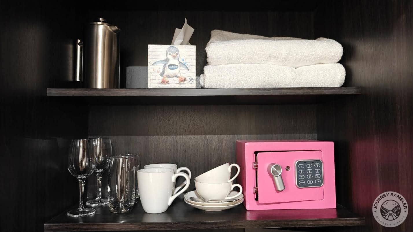 box of tissues, extra bath towels, a kettle, glasses, cups and mugs and also a cute pink locker
