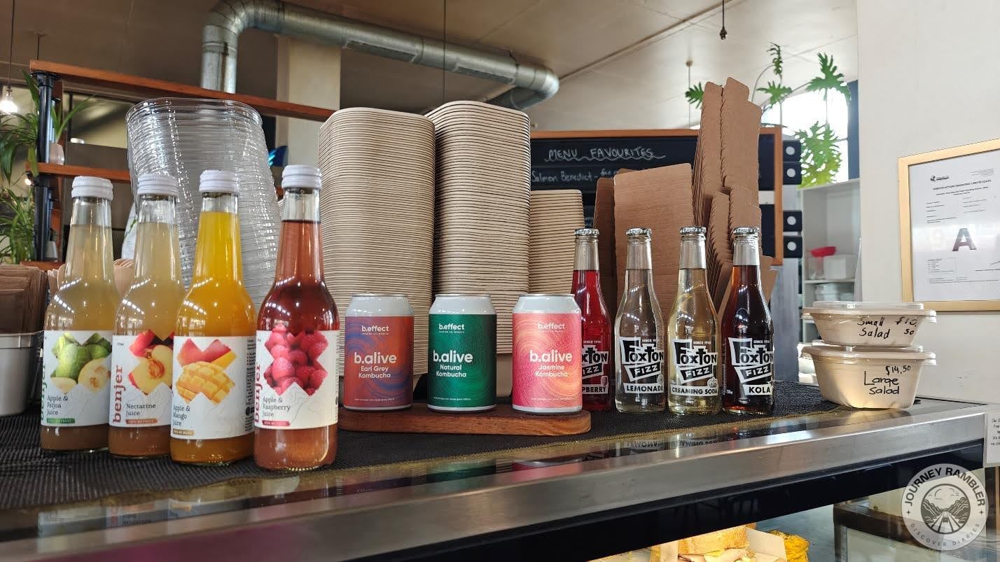 café had displayed all the drinks and sodas that they had on the counter