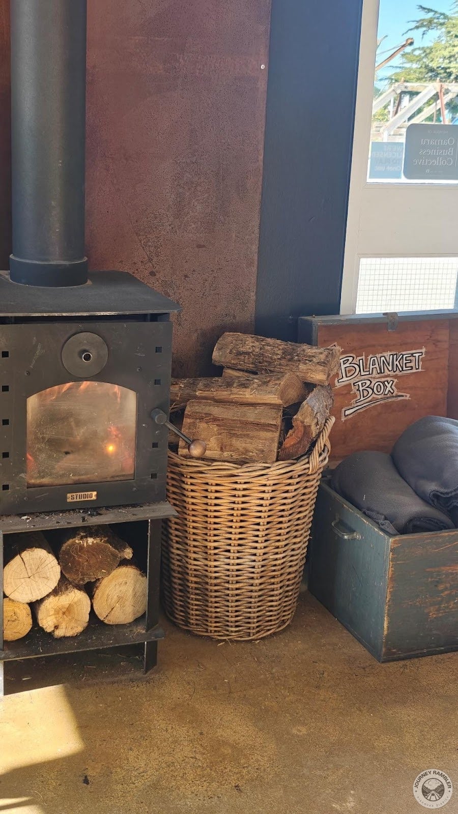 cane basket filled with big chunks of wood