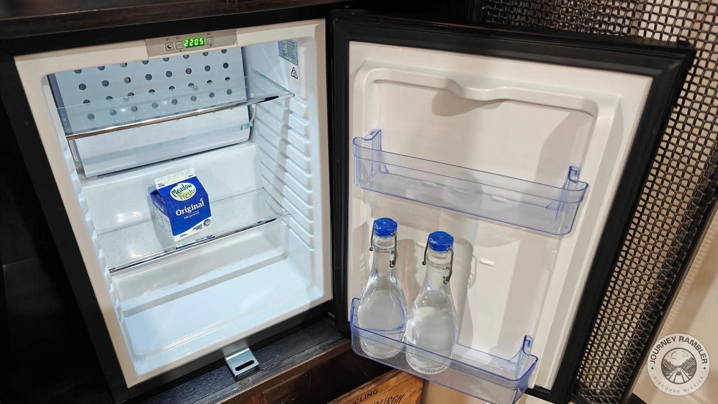 carton of milk along with two glass bottles full of water