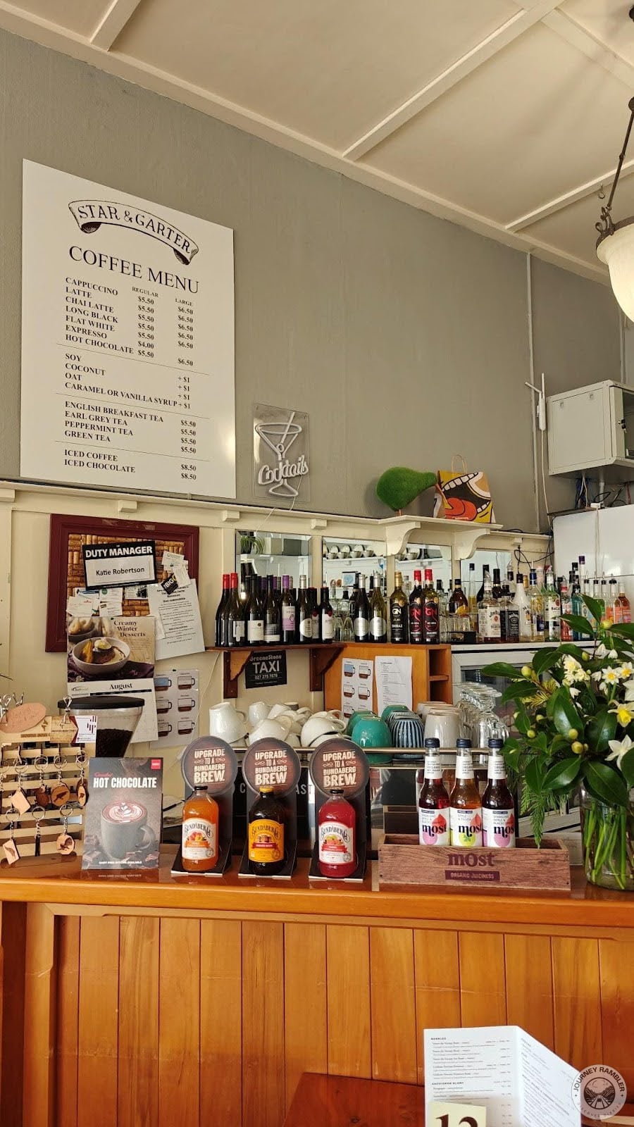 coffee menu hanging above counter