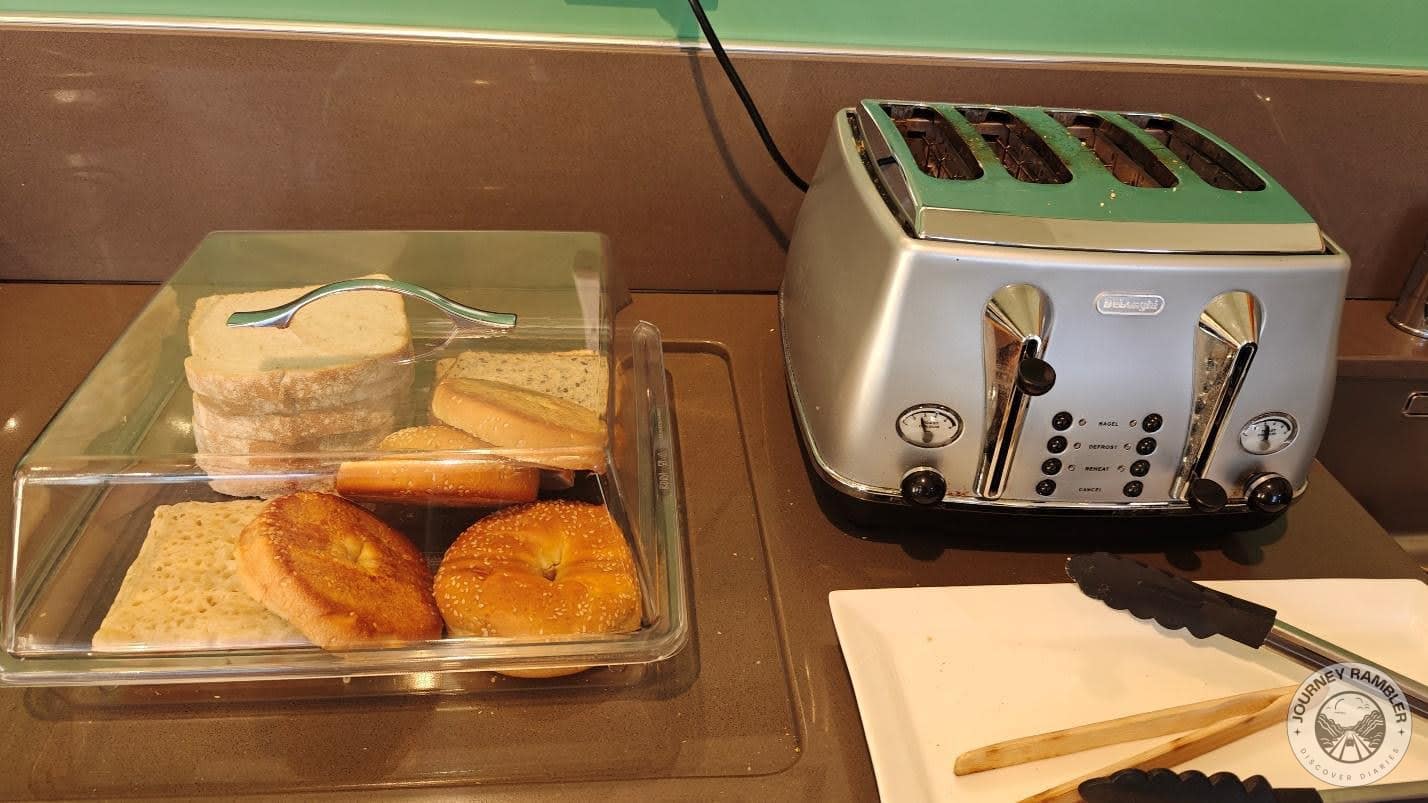 container filled with bread and bagels was kept right beside the toaster
