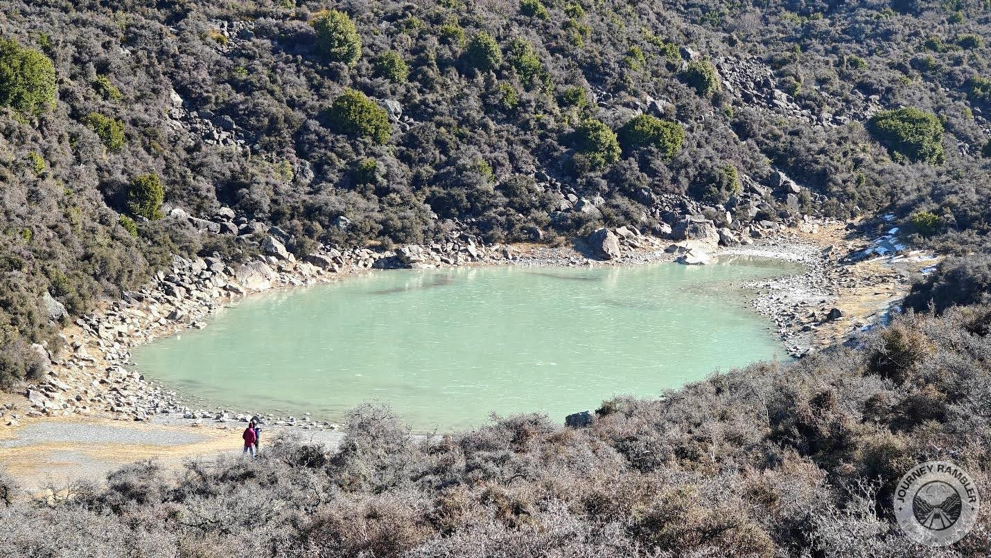 couple of visitors going near this lake's edge