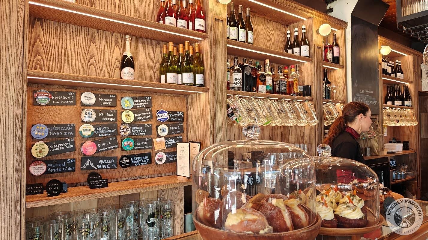 cupcakes and pastries sitting inside pastry cases