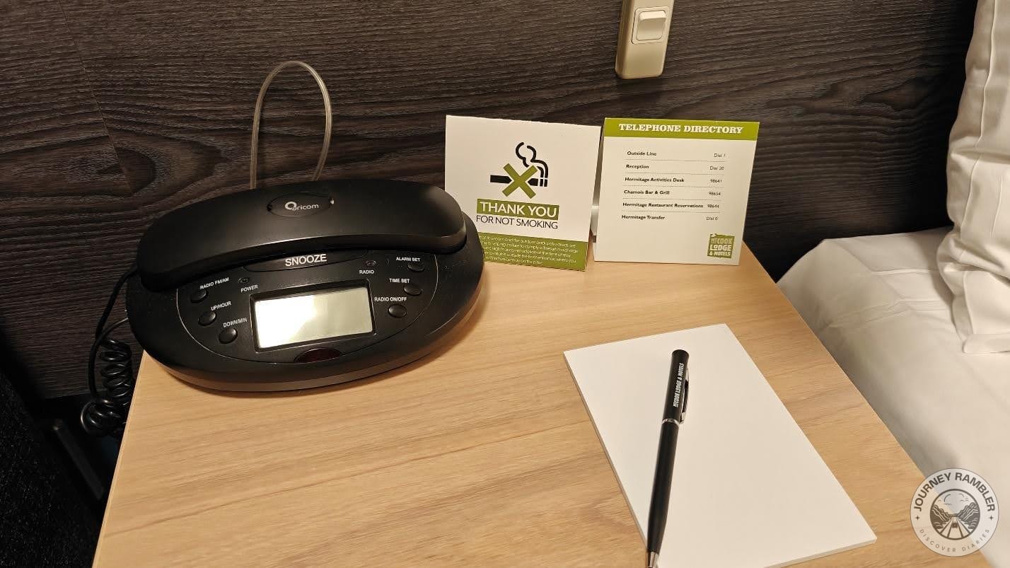 digital alarm clock, a telephone directory to call for help and some pen and paper