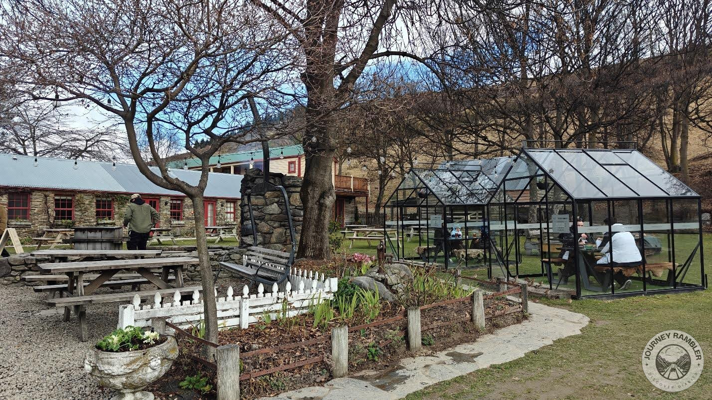 few people were sitting inside the glass houses