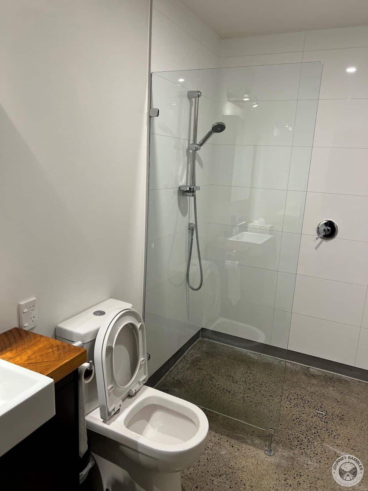 glass partition separated the shower area from the rest of the bathroom