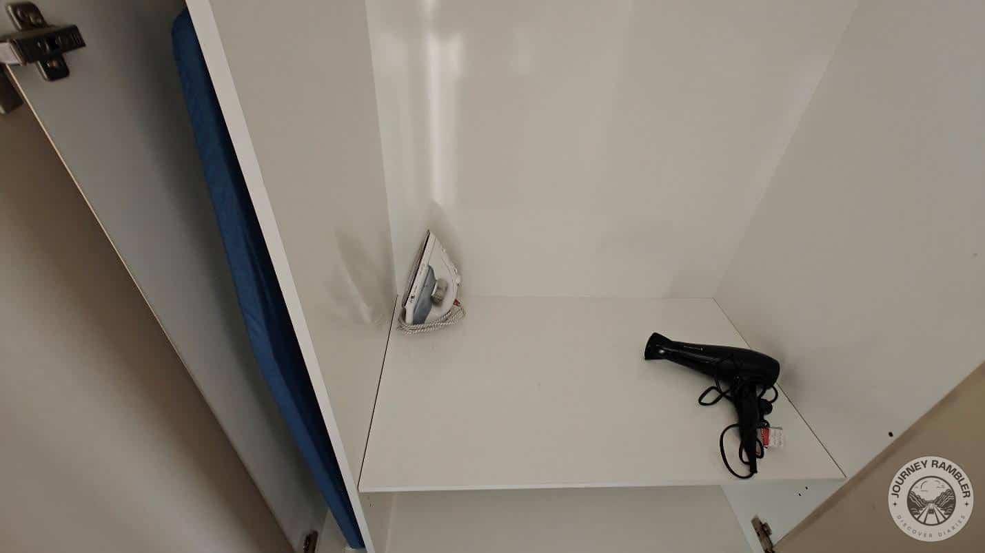 hairdryer, an iron and ironing board