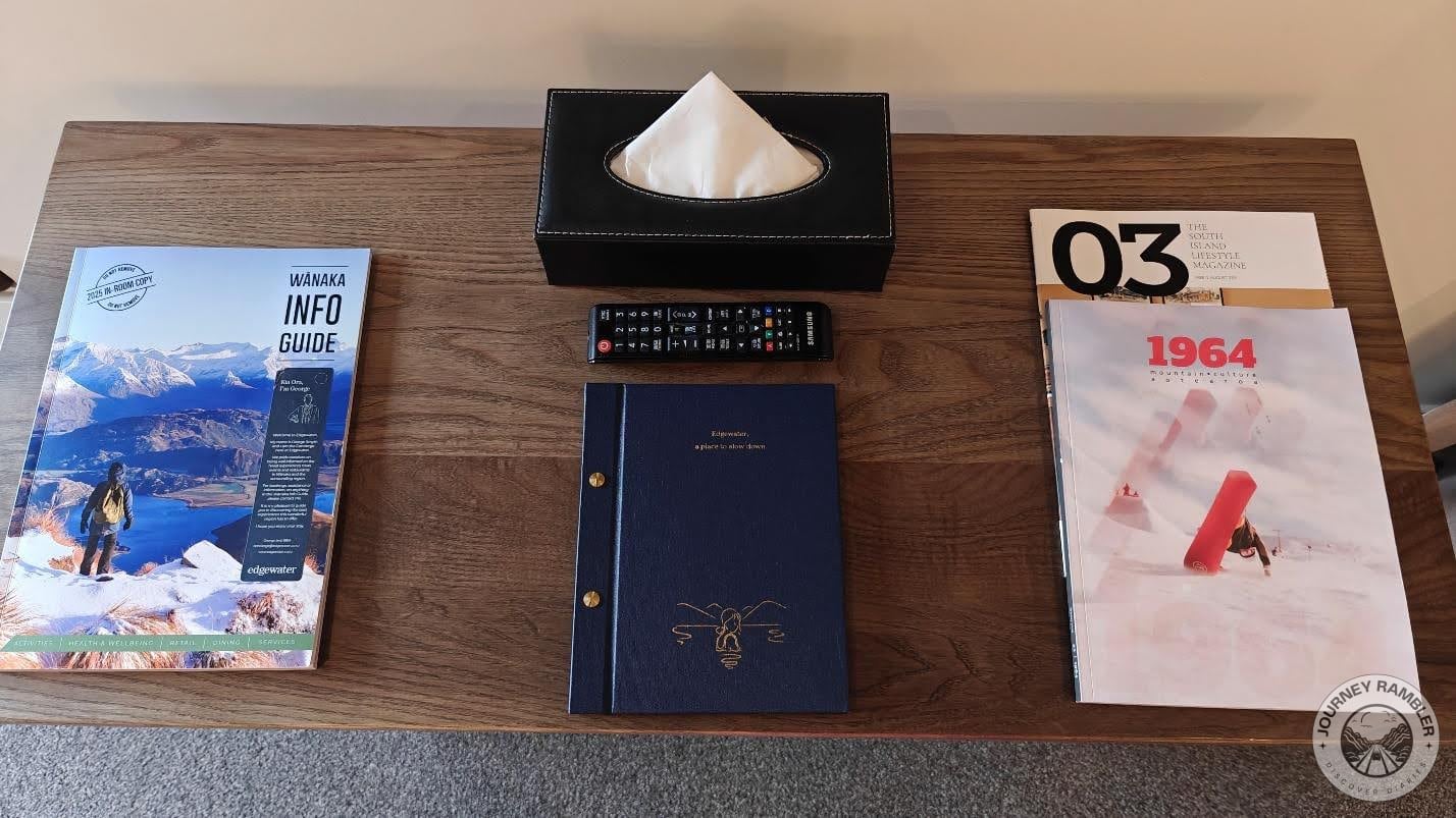 info guides, magazines and a box of tissues on the table