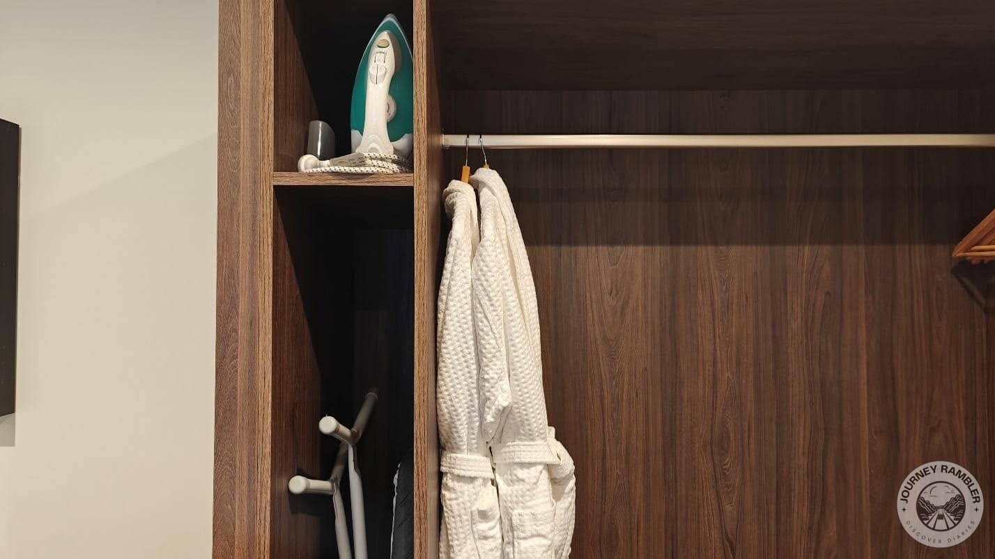iron, an ironing board and two bathrobes
