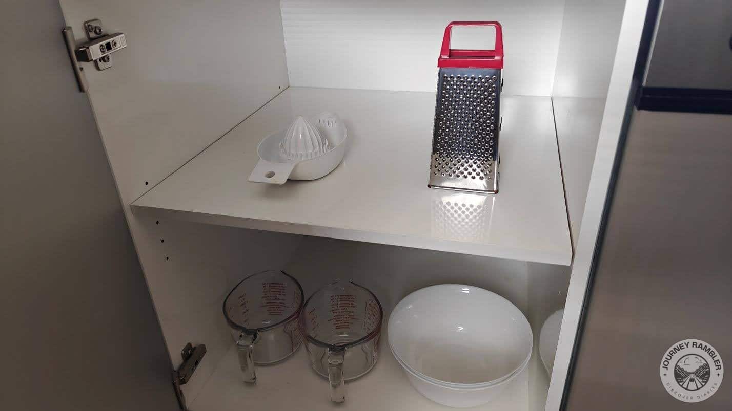 juicer, cheese grater, measuring cups and some serving bowls
