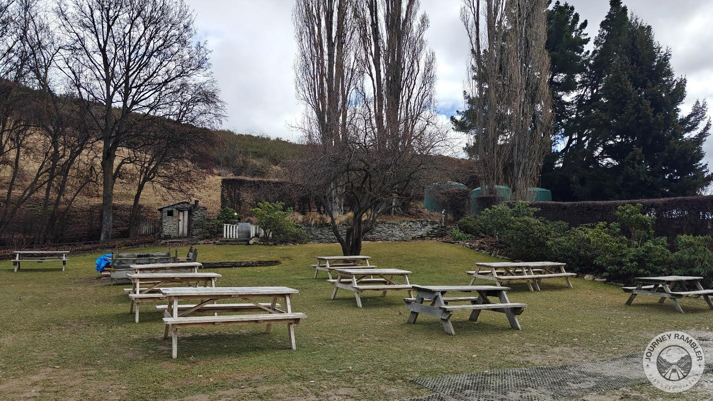 picnic benches and tables scattered on the lawn
