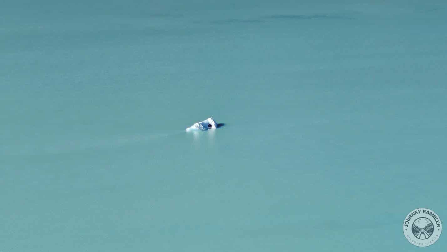 surface of the lake with a piece of ice poking through it